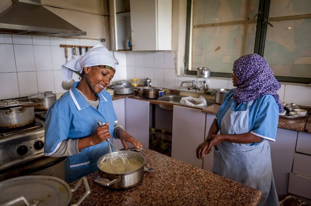 Desta Mender residents work in the kitchen preparing a variety of meals. (Photo by Mary F. Calvert)